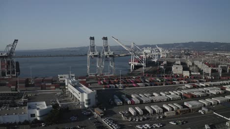 a large industrial shipping operation with cranes and steel shipping containers