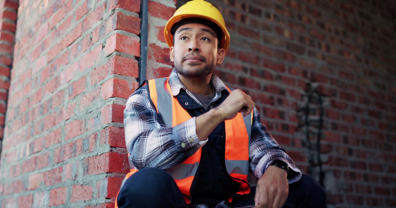 Tired Construction Worker Taking a Break at a Building Site