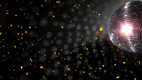 Animation-of-confetti-falling-over-mirror-disco-ball-on-black-background