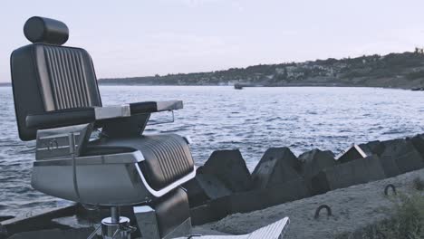 retro hairdresser chair standing on evening sea shore. hairdressing on beach