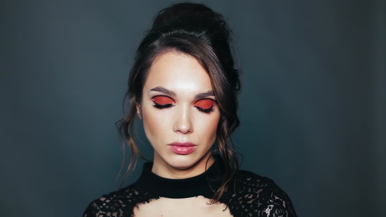 Portrait of pretty woman crying. Beautiful girl with red mascara on eyes crying