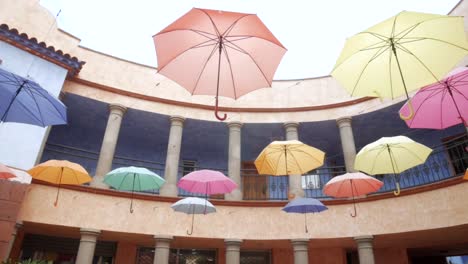 colorful umbrellas hanging in  courtyard in spain