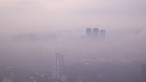 foggy view of mysterious skyline and hills in kuala lumpur, malaysia