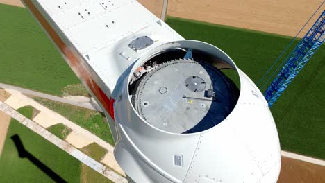 the head of a wind turbine under construction - orbit drone shot