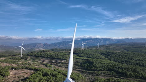 awe inspiring view over a wind farm in the mountains with beautiful blue sky