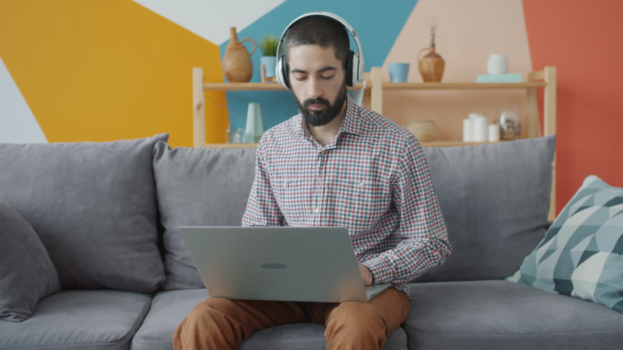 Man Working on Laptop at Home