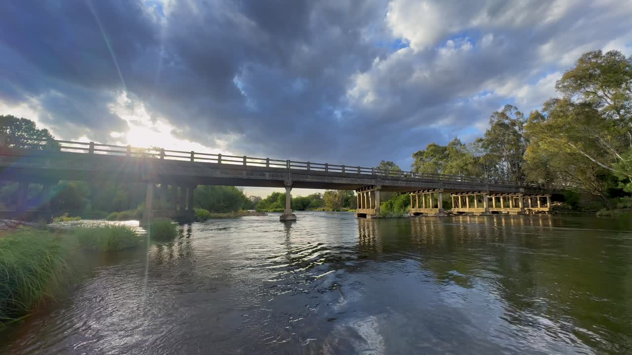 Flowing Goulburn river beneath bridge, surrounded by serene Australian wilderness beauty