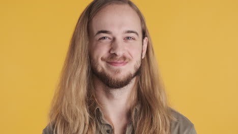 caucasian young man winking at the camera.