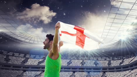 animation of dust floating over caucasian man holding english flag at stadium