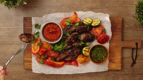 Crop-person-eating-Salisbury-steak-with-sauces-and-vegetables