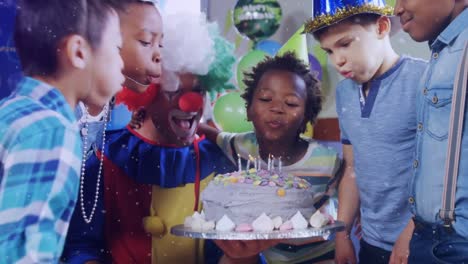 Animation-of-confetti-falling-over-clown-and-children-blowing-candles-on-birthday-cake-at-party