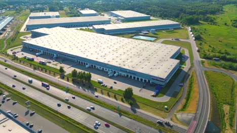 Aerial-view-of-warehouse-storages-or-industrial-factory-or-logistics-center-from-above