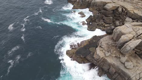 Drone-aerial-moving-forward-over-rugged-Australian-coastal-cliffs-in-Albany-with-crashing-waves