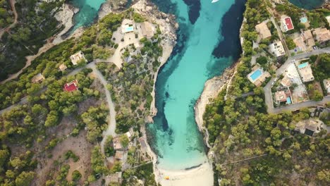 birds eye view of the beautiful cala llombards with clear blue turquoise water at the east coast of mallorca in 4k - drone video