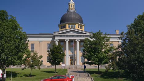 Tilt-down-onto-the-road-of-the-front-of-the-Beautiful-Ontario-County-Courthouse-in-Canandaigua,-New-York-near-Canandaigua-Lake