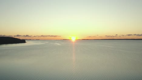 aerial: drone footage of sunrise over a lake in denmark