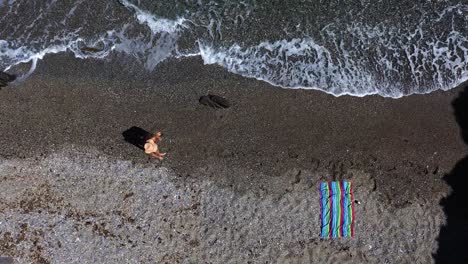 people at the beach aerial drone view playing beach tennis, sunbathing, enjoy holidays at the seashore