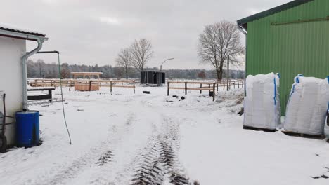 Aerial-view-of-a-snowy-farm-with-horses-in-northern-germany