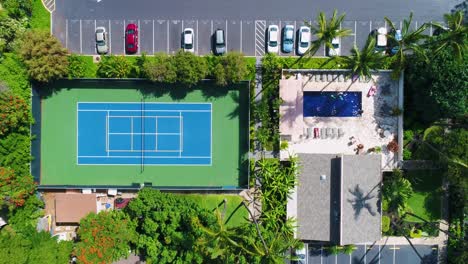 tennis court, parking lot with cars and people in a pool, overhead aerial view moving forward
