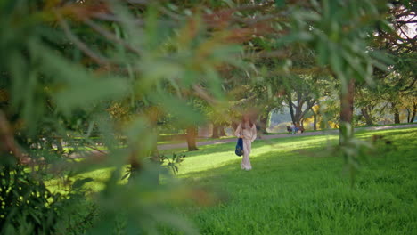 peaceful woman walking green park. girl enjoying nature tranquility at summer