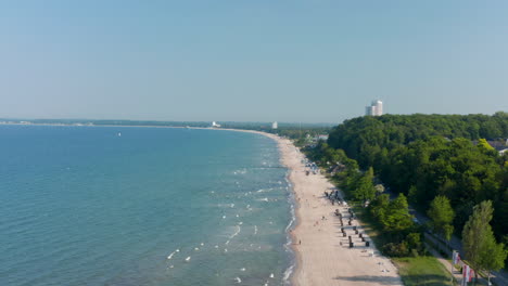 Aerial-view-of-beach-coastline-in--Scharbeutz,-Germany,-dolly-in,-summertime-day