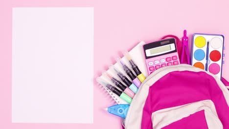school tools appear from pink backpack and wrapped paper unwrap for text. stop motion