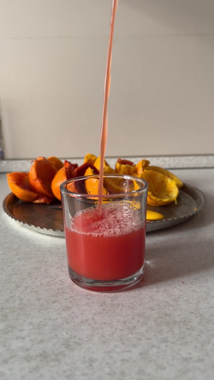 Pouring fresh orange juice in a glass Cold organic citrus lemonade drink pulpy vitamin Handmade Persian kitchen preparation Healthy breakfast lifestyle wellness Tehran ripe fruit refreshment nutrition