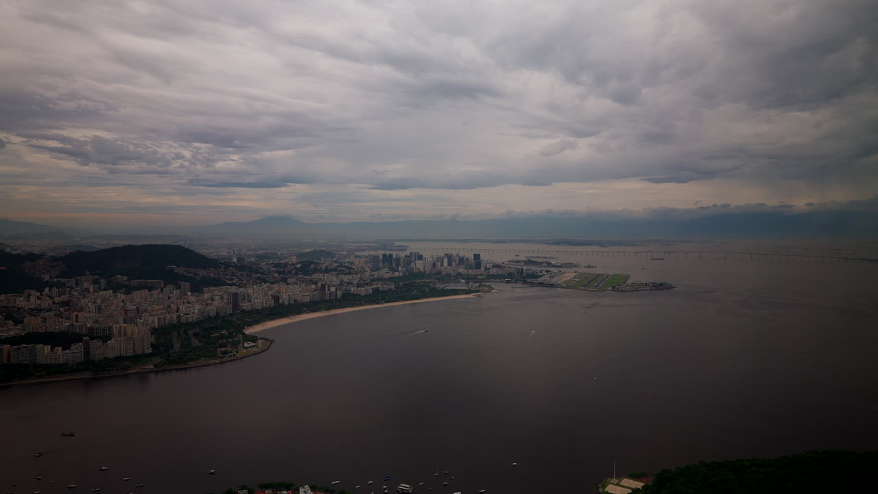 Cloudy Sky Over Coastal City Of Rio de Janeiro Near Sugarloaf Mountain In Brazil. wide aerial shot