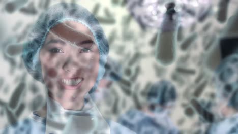 animation of covid 19 cells over smiling biracial female surgeon in operating theatre