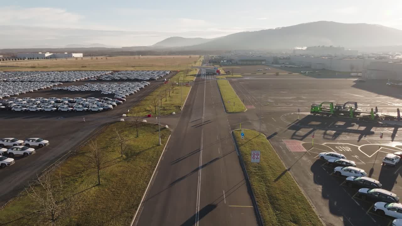 Flying over highway near mass storage parking lot in vast area
