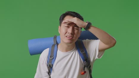 man with backpack looking up