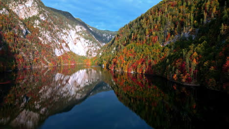 flying in middle of steep mountains, autumn in toplitzsee, austria - aerial view