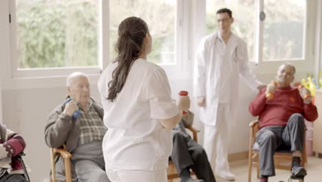 physiotherapist explaining the exercises to a group of seniors
