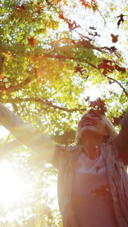 happy woman throwing maple