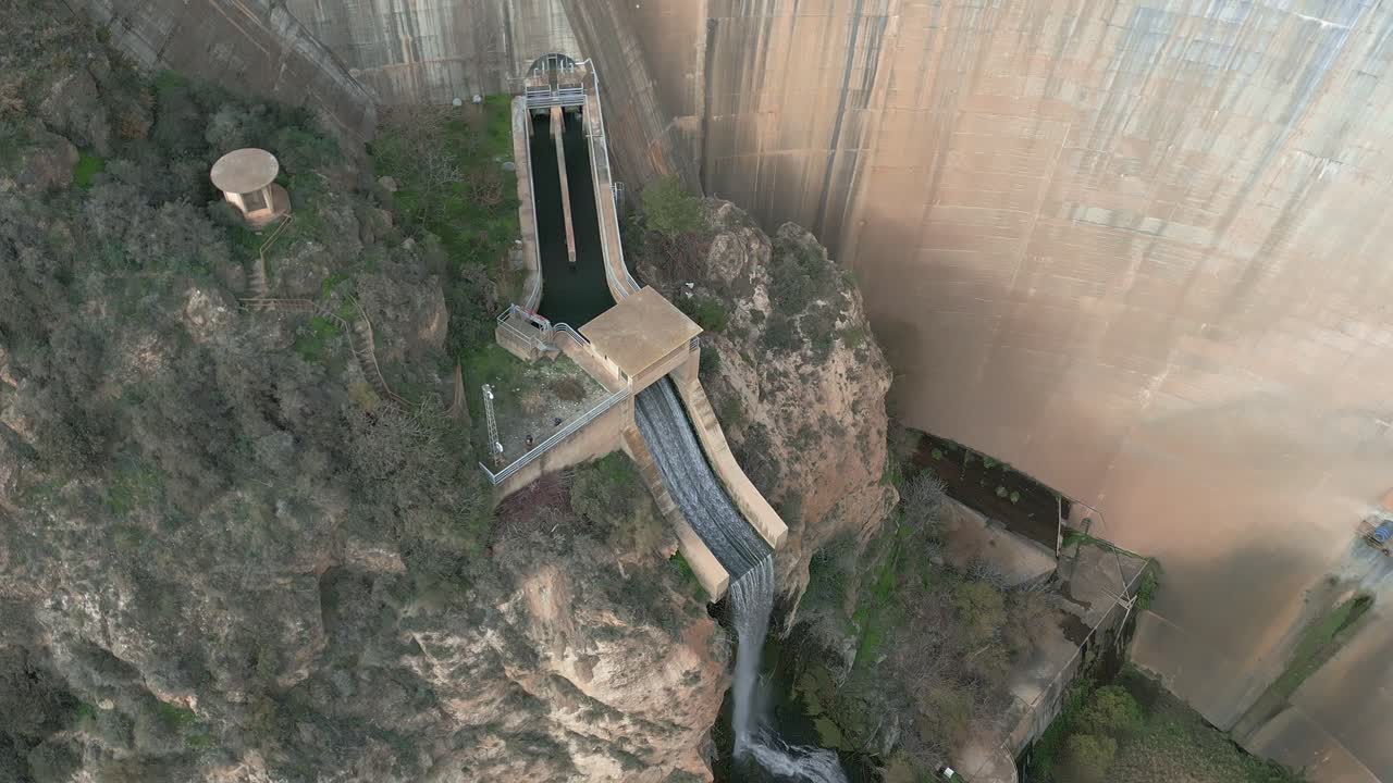 Dam overflow pouring water for ecological flow from the dam
