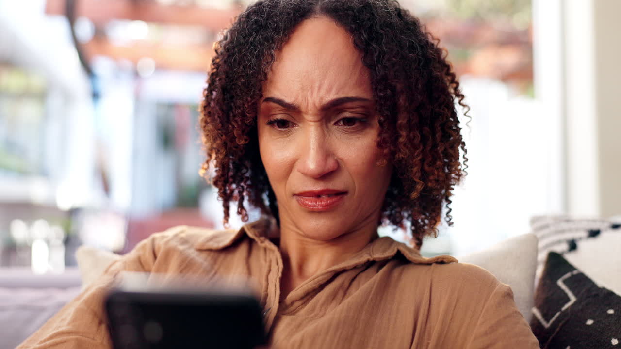Concerned woman looking at smartphone