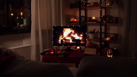 cozy christmas living room with fireplace on tv screen