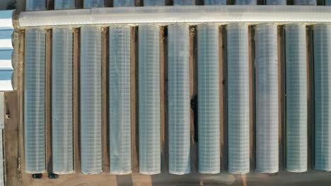 aerial top down, rows of industrial greenhouse nursery farms