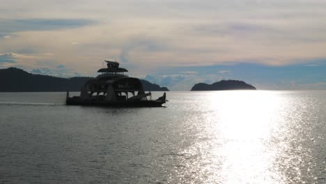 a ferry crossing on the ocean in the sun light reflection slowmo