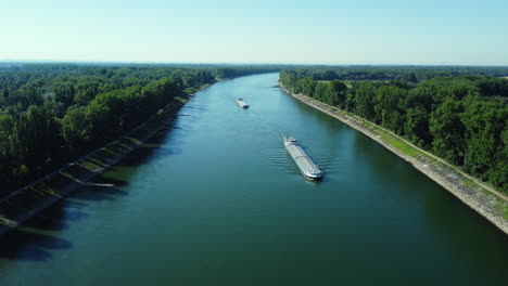 canal with barges and lush green banks