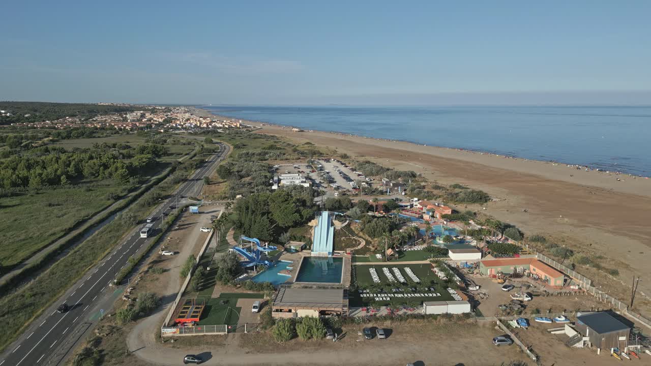 Aquatic Park Aerial Drone Fly French Beach landscape, road traffic in Narbonne commune