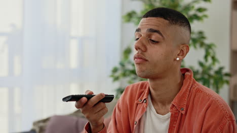 man watching tv with remote
