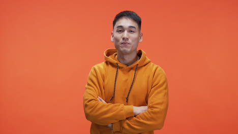 man laughing in orange hoodie