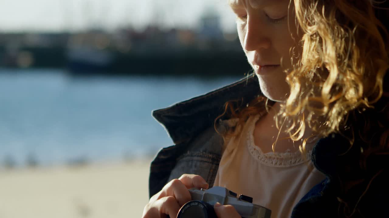 Woman clicking photo with camera at dock 4k