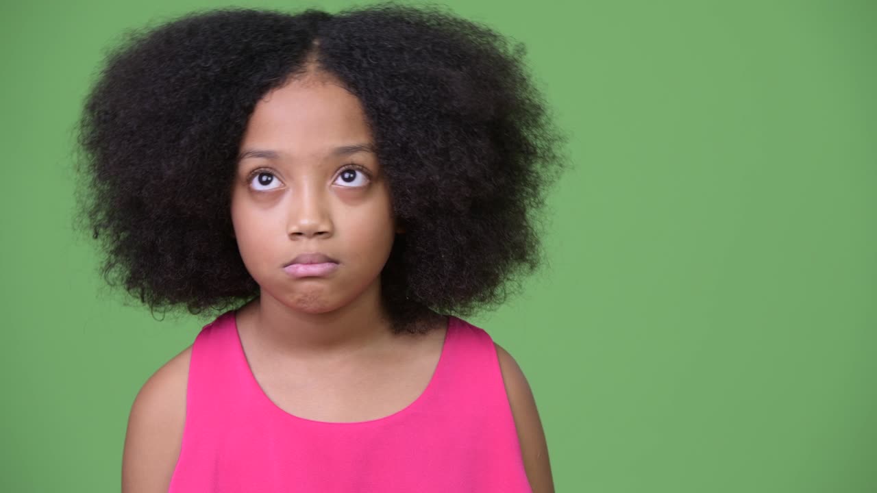Young cute African girl with Afro hair looking bored