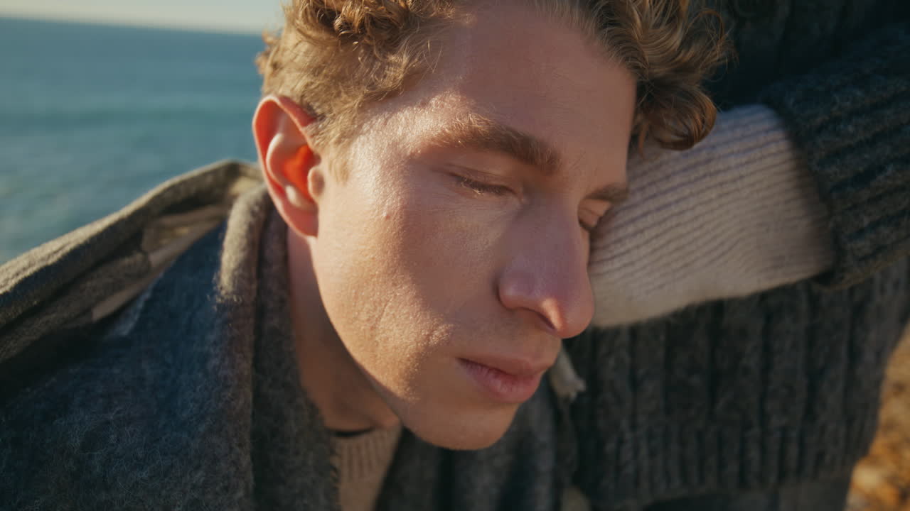 Sad man leaning woman sunshine sea background closeup. Love couple together