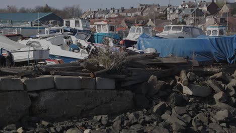 old boats abandoned in crumbling harbor making a ship graveyard