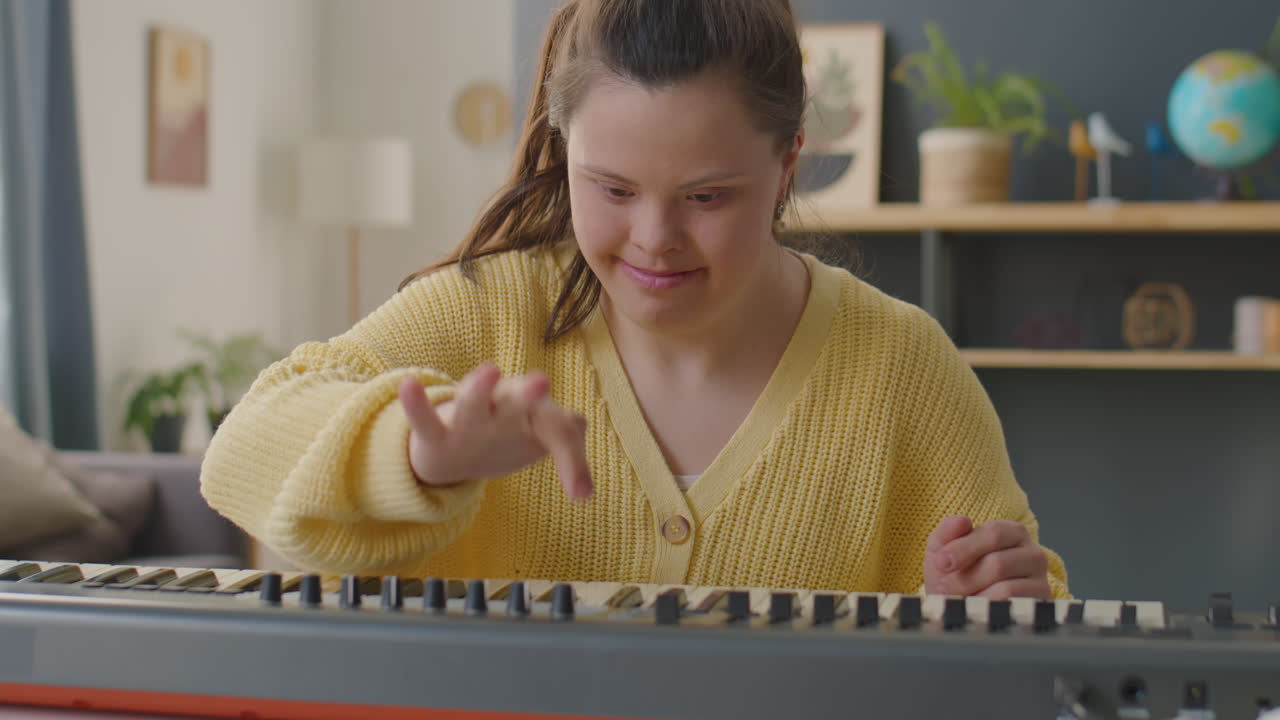 Girl with Down Syndrome Learning Synthesizer at Home