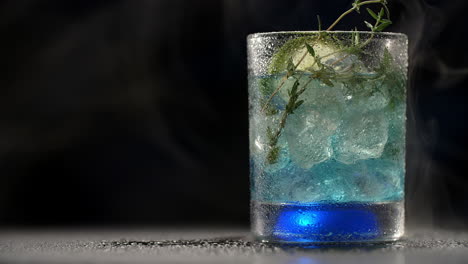 blue cocktail with thyme
