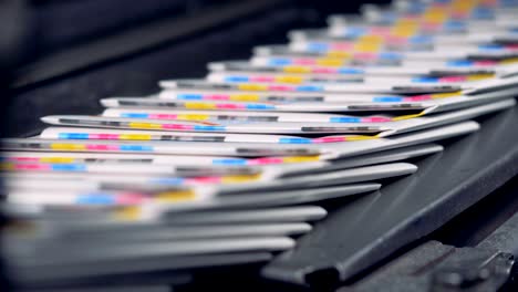 a big amount of ready-made newspapers on a printing house conveyor.